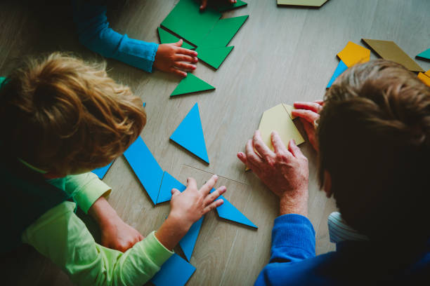 istock teacher and kids playing with geometric shapes 1030796126
