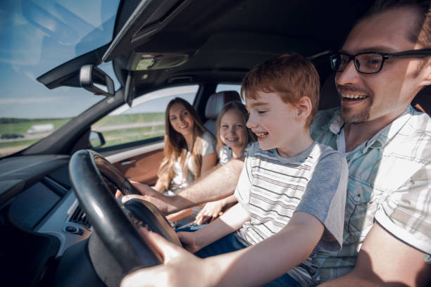 istock funny father and his little son driving a car 1030798534