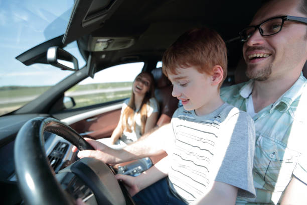 istock father and his little son driving a car 1030798748