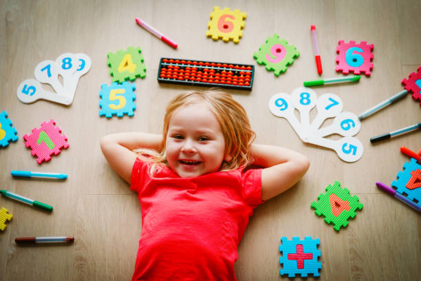 istock little girl learning numbers, mental arithmetic, abacus calculation 1030798802