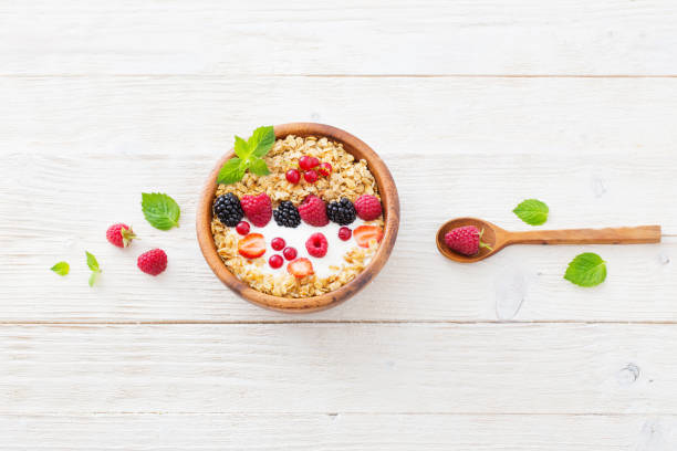 istock granola with berries on white wooden background 1030798960