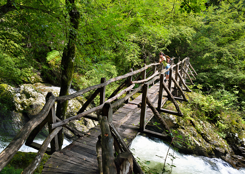 Ecopath White River, Balkan Mountains, Bulgaria - July 29, 2018: Tourist on a bridge over the river White River at the ecopath White River in Stara Planina, Bulgaria. Balkans, Europe.