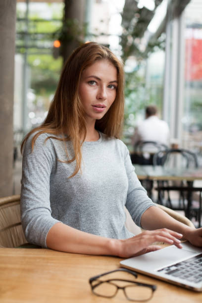 istock business woman behind her desktop 1030803458
