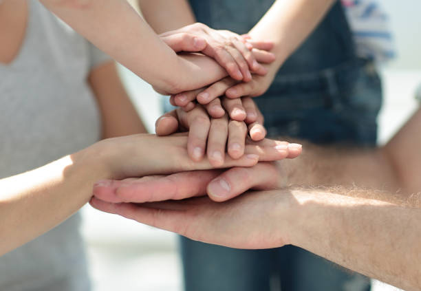 istock close up.family hands folded together 1030804094