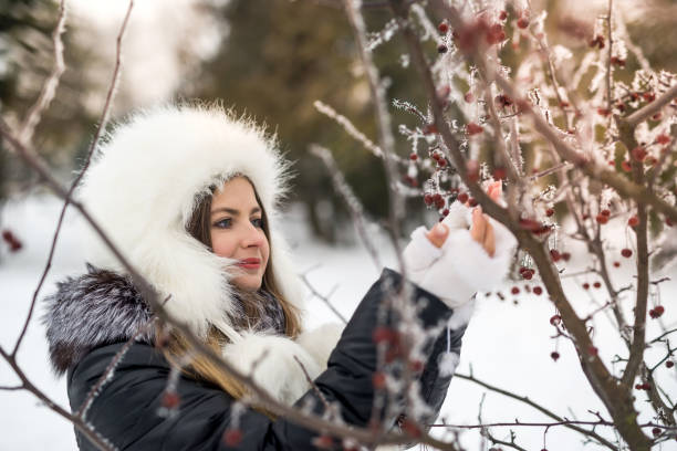 istock Young attractive woman in winter park with tree branches 1030806694