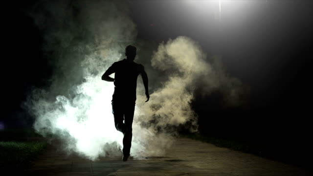 The fellow running in the cloud of smoke on the dark background, slow motion