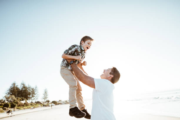 istock little son enjoying with the father at the beach 1030823656