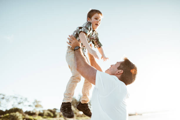 istock little son enjoying with the father at the beach 1030824138