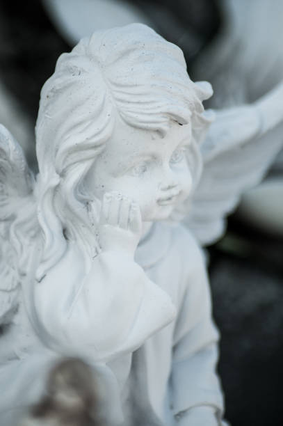 istock stoned angel on tomb in cemetery 1030826730