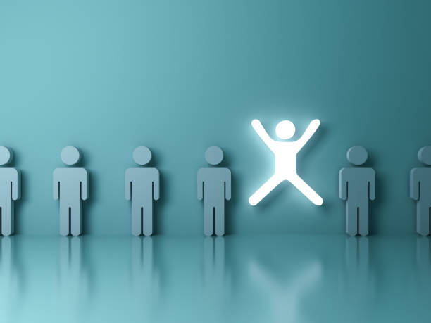 istock Stand out from the crowd and different concept One glowing light man jumping with legs and arms wide open among other people on dark green pastel color background with reflections and 3D rendering 1030827902