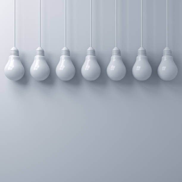White hanging light bulbs on white wall background with blank space for decoration 3D rendering
