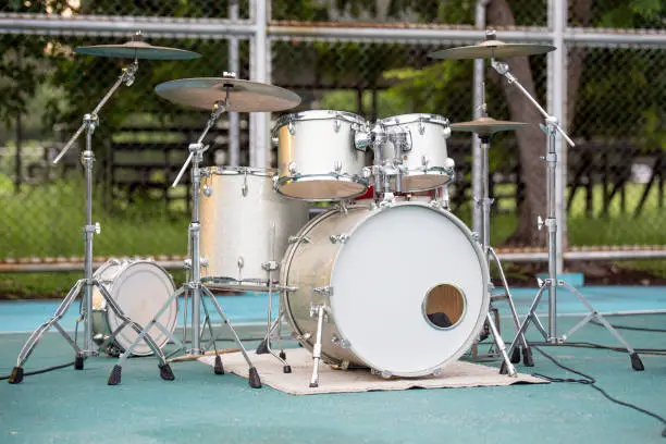 Photo of gold drum set on background blurred