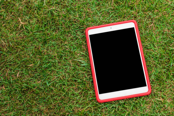 istock tablet 8.4 inches on green glass 1030831762