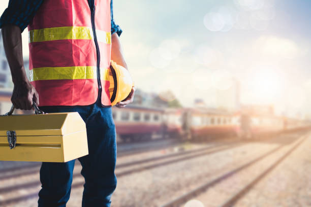 istock Construction worker or technician  holding tools box and helmet at soft blur train station background, ready to repair and fix concept 1030832712