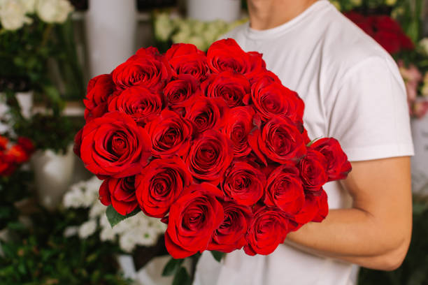istock Man holding bouquet of roses 1030836004