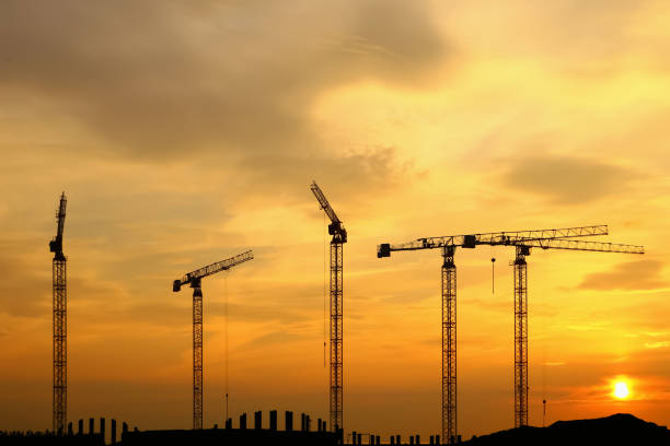 istock silhouette of construction and cranes in the evening on the sunset 1030836656