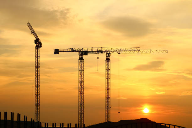 istock silhouette of construction and cranes in the evening on the sunset 1030836664