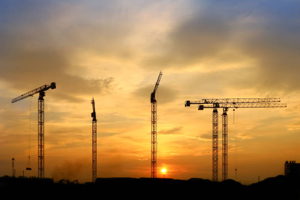 istock silhouette of construction and cranes in the evening on the sunset 1030836670