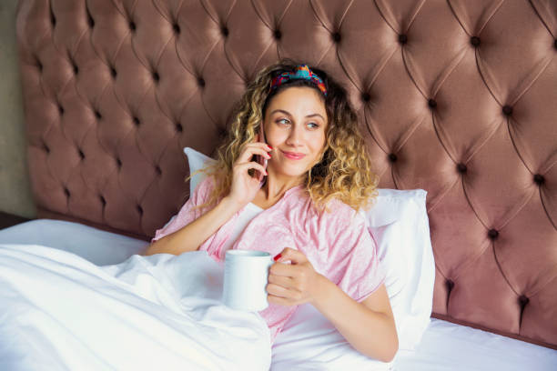 istock Girl using smart phone and lying down in bed 1030840240
