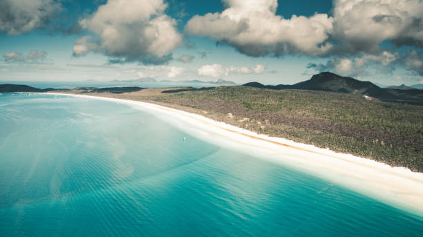 istock whitsunday beach with a boat 1030841052