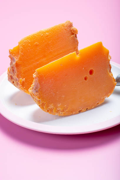 Two pieces of native French aged cheese Mimolette, produced in Lille with greyish curst made by special cheese mites