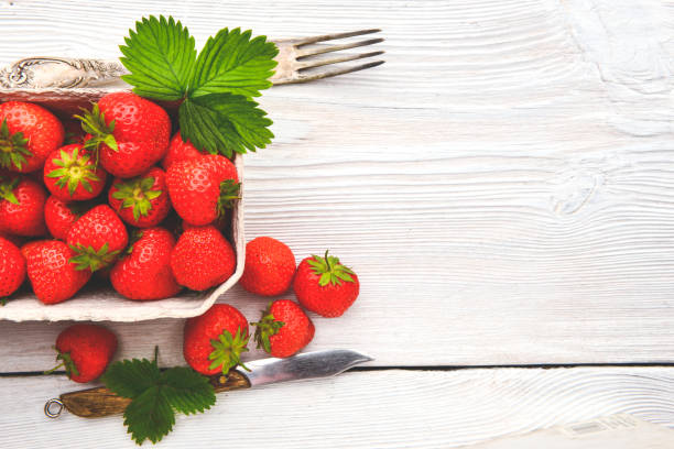 istock Fresh strawberry in a box on wooden table 1030842094