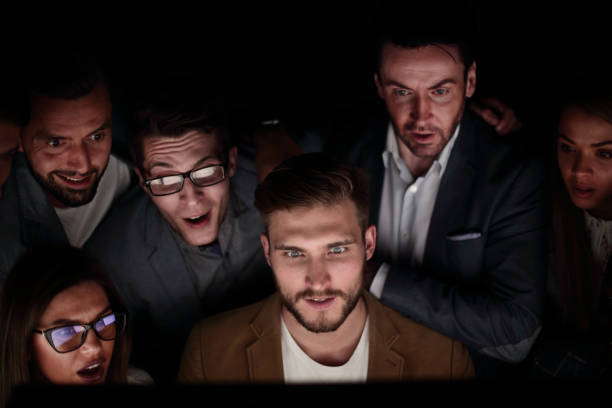 istock close up. the programmer and his colleagues are working late 1030849558