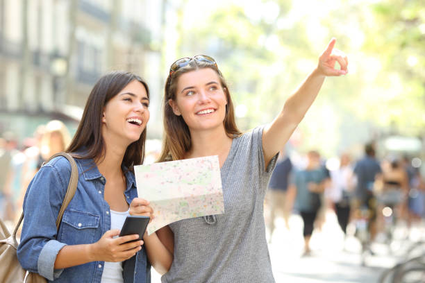 istock Tourists sightseeing holding a map and pointing up 1030850036