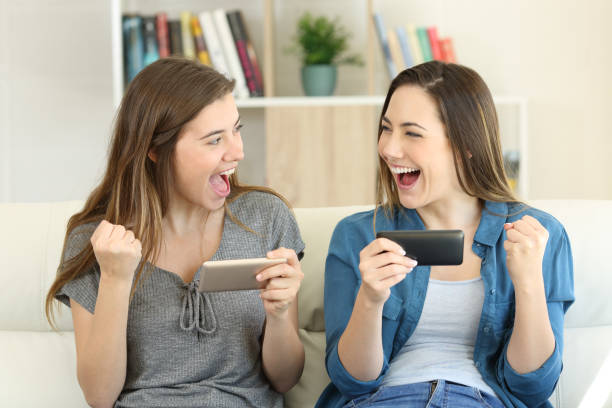 istock Excited friends playing online game and winning 1030850392
