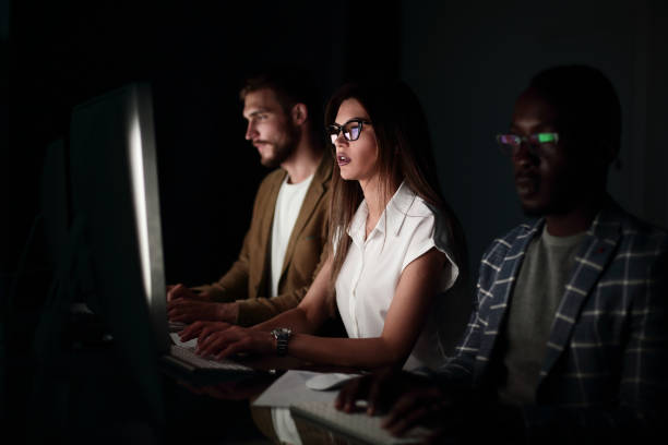 istock financial team sitting in an office in front of a computer at night 1030850398