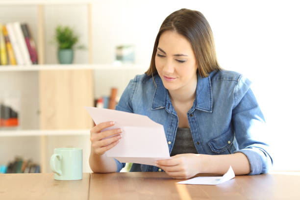 istock Relaxed lady reading a letter at home 1030850770