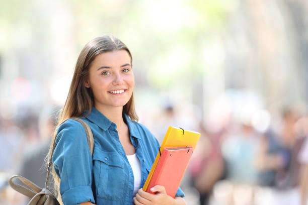 istock Student posing smiling in the street 1030850784