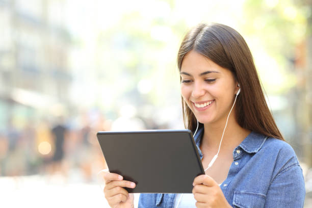 istock Girl watching streaming videos online in a tablet 1030850850