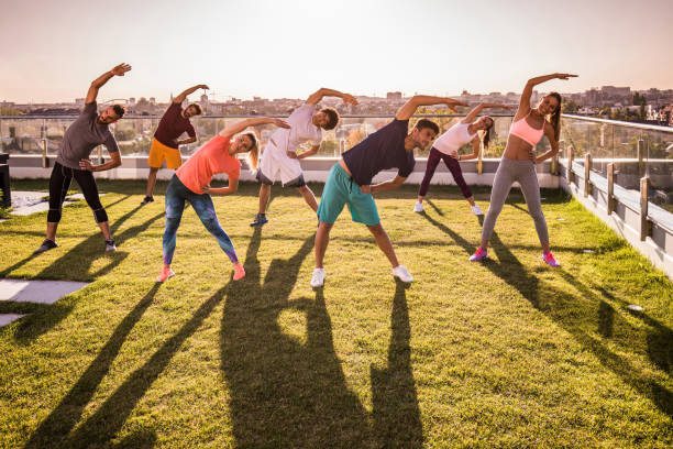 istock Large group of athletes warming up on a penthouse terrace. 1030852638