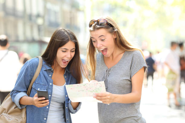istock Excited tourists traveling finding location in a guide 1030853236