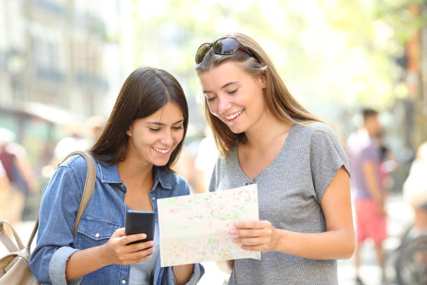 istock Tourists traveling consulting a phone and a guide 1030853446