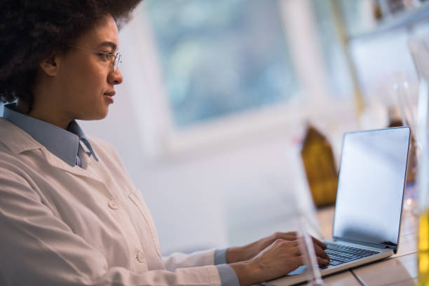 istock African American biotechnologist working on laptop in a laboratory. 1030853476