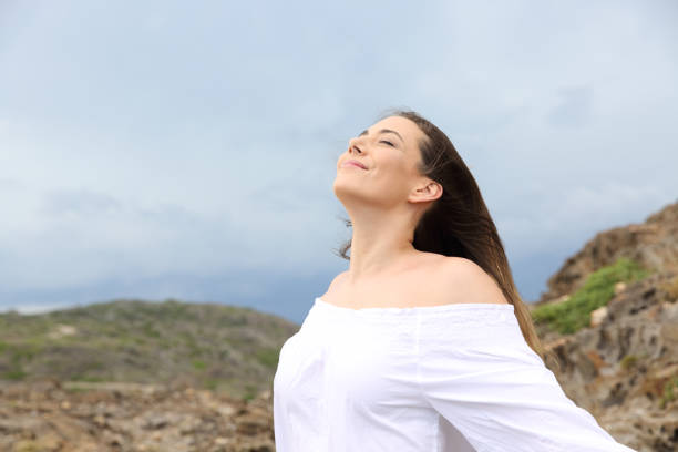 istock Woman breathing with a storm in the background 1030853564