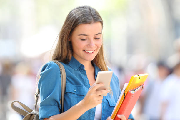 istock Student uses a smart phone in the street 1030853696