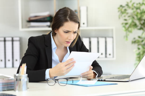 istock Worried office worker reading news in a letter 1030853768