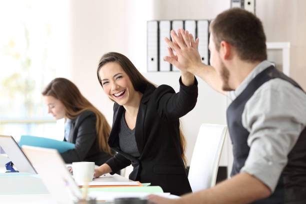 istock Two happy coworkers celebrating success at office 1030854142