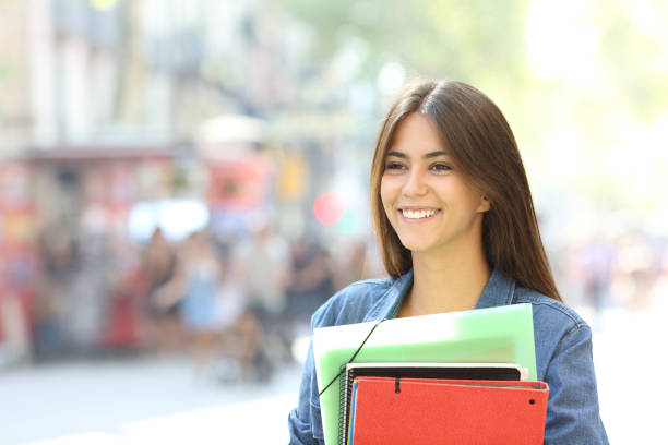 istock Happy student walking on the street 1030854694