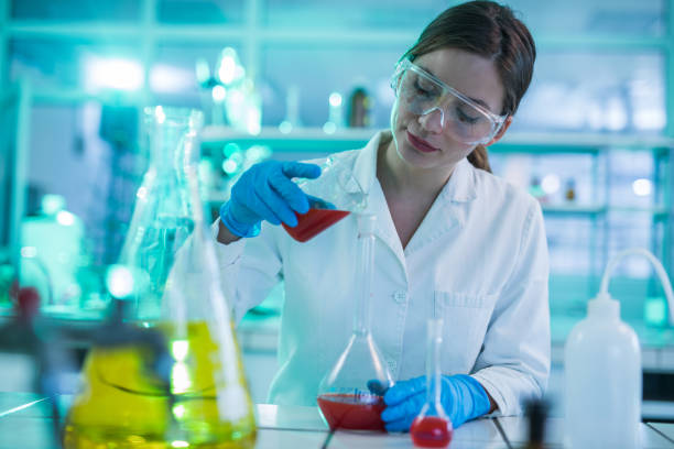 istock Young female scientist mixing toxic substances in laboratory. 1030856936