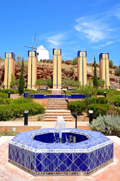 istock Fountain with windmill to rear, Castro Marim. 1030858554