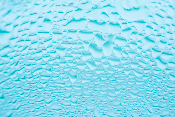 istock Glass with transparent water rain drops patterns. Sweated surface of cool beverage drink. Freshness hydration purity concept. Abstract backdrop. 1030861654