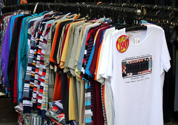 KAOHSIUNG, TAIWAN -- AUGUST 18, 2018: A street vendor at the Nan Hua tourist market sells cheap t-shirts.