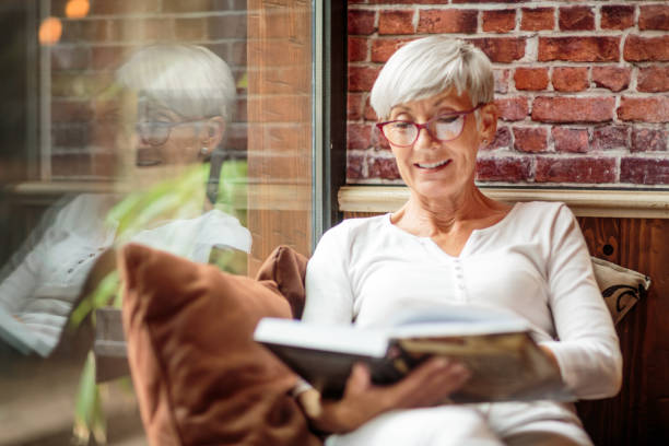 istock Senior woman reading a book 1030871054