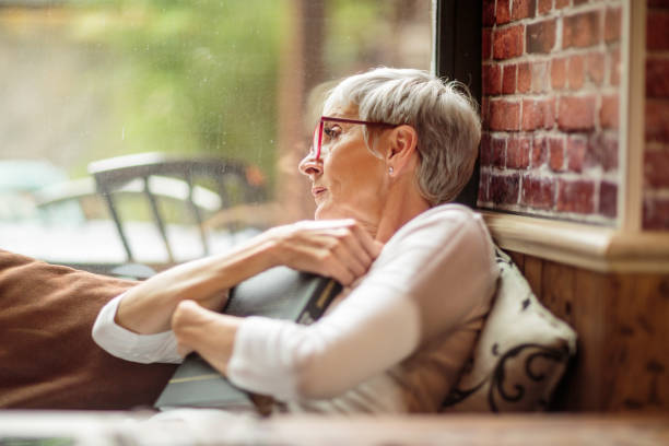 istock Senior woman hugging a book 1030871304