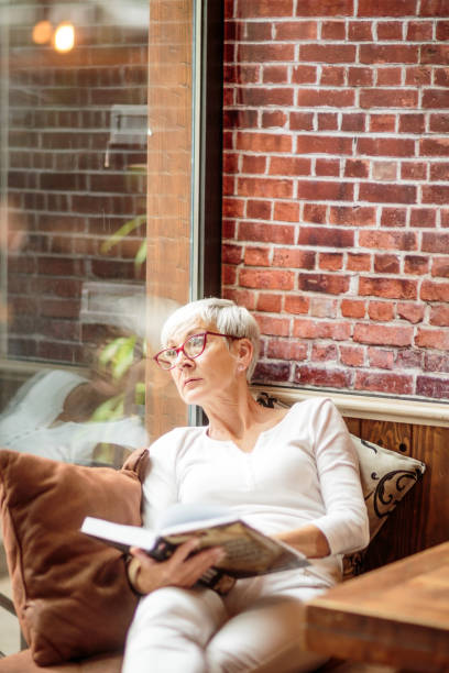 istock Senior woman holding a book 1030871312