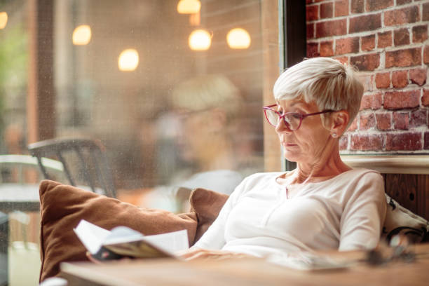 istock Senior woman reading a book 1030871348